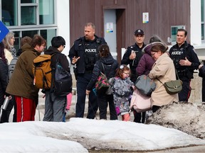 Ottawa Police were called to Consortium Centre Jules-Léger in Ottawa Wednesday. Eventually the police left without incident. Police talk to people outside the school Wednesday morning.
