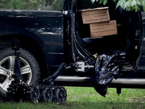 The truck driven through the gates of Rideau Hall by Corey Hurren sits open during an inspection by police in July 2020.