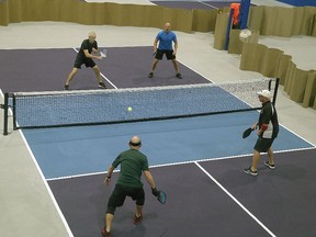 Pickleball players, Terry Fitzpatrick, front left and Mike Shkimba play against Ron Heidebrecht, rear left and Gunther Mally take part in a men's ladder match at the Kingston Pickleball Club at 1150 Gardiner's Road in Kingston on Thursday September 15, 2022.