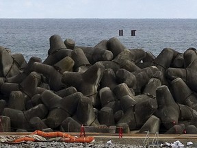 This photo taken during a visit by Associated Press journalists to the tsunami-wrecked Fukushima Daiichi nuclear power plant, four pillars are seen as an indicated point on Feb. 22, 2023, off the coast along the power plant, where an undersea tunnel through which the treated radioactive wastewater is released into sea is being constructed.