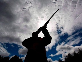 A rifle owner checks the sight of his rifle at a hunting camp property in rural Ontario.