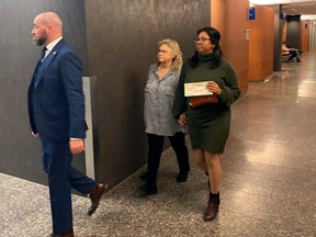 Sandra Helm walks in the hallway at the Montreal courthouse in Montreal on Tuesday, January 18, 2023. The U.S. woman who was kidnapped along with her husband and smuggled into Quebec in October 2020 says she still lives in constant fear something will happen to her.