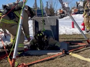 An Ottawa Fire Services crew member leaves the entrance to a tunnel at Tunney's Pasture, where an electrical fire was extinguished on Wednesday afternoon.