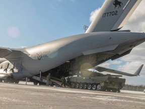 A Leopard 2A4 tank is loaded onto a Royal Canadian Air Force CC-177 Globemaster III to be sent overseas as part of Canada's aid to Ukraine in Halifax on Feb. 3.