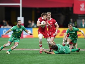 Canada's Phil Berna (4) is stopped by Ireland's Harry McNulty (3) during HSBC Canada Sevens rugby action, in Vancouver, on Friday, March 3, 2023.