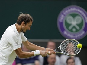 Russia's Daniil Medvedev plays a return to Poland's Hubert Hurkacz during the men's singles fourth round match on day eight of the Wimbledon Tennis Championships in London, Tuesday, July 6, 2021.