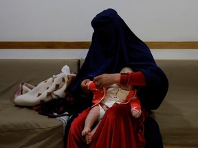 An Afghan woman tends to her child at a hospital in Bamiyan, Afghanistan, March 2, 2023.