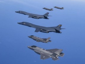 FILE - In this photo provided by South Korea Defense Ministry, U.S. Air Force B-1B bombers, center, fly in formation with South Korea's Air Force F-35A fighter jets over the South Korea Peninsula during a joint air drill in South Korea, Sunday, March 19, 2023. North Korea on Monday, March 20, described its latest ballistic missile launch as a simulated nuclear attack on South Korea as leader Kim Jong Un called for his nuclear forces to sharpen their war readiness in the face of his rival's expanding military exercises with the United States.