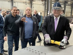 Ontario Premier Doug Ford practices his welding on Thursday, Feb. 16, 2023 at SIS Manufacturing in Sault Ste. Marie while announcing an investment of $5.8 million to help junior mining companies explore for critical minerals.
