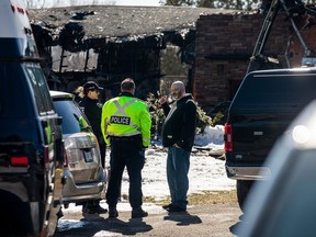 Ottawa Fire Services speak to a resident of the home, Cory Hilliard.