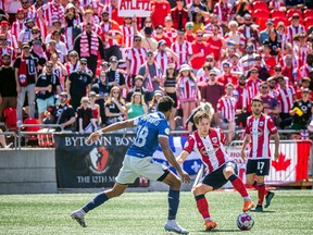 Atlético Ottawa host the Halifax Wanderers for their home opener at a TD Place Saturday, April 15, 2023. The pay what you can event was also a fundraiser for the CHEO Foundation. Halifax's Andre Jesse Rampersad tries to get the ball from Ottawa's Noah Timothy Verhoeven.