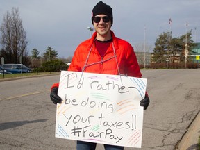 A striking PSAC worker outside the Canada Post building on Riverside Drive.
