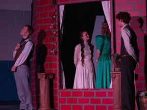 Algernon Moncrieff played by Daniel Kingdom (L), Cecily Cardew played by Adele Grootenboer (2nd FL), Gwendolen Fairfax played by Phoebe Stassen (2nd FR), and John “Jack” Worthing played by Joseph Carriere (R) during Redeemer Christian High School’s Cappies production of The Importance of Being Earnest, held on April 22, 2023.