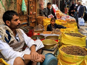 Dried fruit merchants sit with their merchandise at a market in Yemen's capital Sanaa on April 20, 2023 ahead of the Eid al-Fitr at the end of the Muslim holy fasting month of Ramadan.