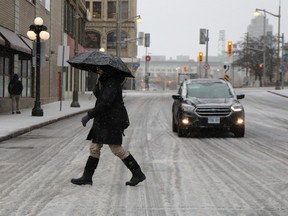 A woman walks down Wellington during a nasty ice storm.