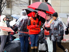 PSAC strikers on Elgin Street on Monday came prepared for a bit of spring rain.