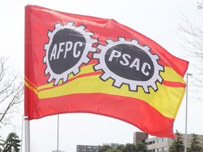 File photo: A flag of the Public Service Alliance of Canada. The bargaining group representing workers at Canada's borders says it's postponing its negotiations with the federal government in support of public servants who are on strike across the country.
