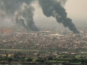 This image grab taken from AFPTV video footage on April 28, 2023, shows an aerial view of black smoke rising over Khartoum, Sudan.