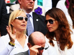 FILE - Martina Navratilova and Julia Lemigova sit in the Royal Box on Centre Court on day twelve of the Wimbledon Lawn Tennis Championships on July 5, 2014 in London, England.