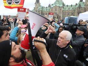 Union president Chris Aylward spoke to reporters at a rally with thousands of striking workers on Parliament’s great lawn. Plenty of the workers complained about their pay on their picket signs, but “I’d rather be working from home.” and “Telework Works” were also prominently on display.