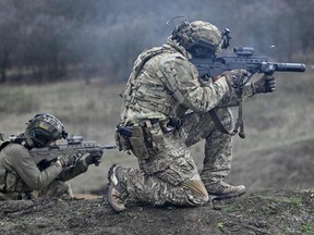 A Ukrainian Special Forces serviceman (R) fires a Ukrainian-made Malyuk assault rifle during a training exercise in Donetsk region on April 6, 2023, amid the Russian invasion of Ukraine.