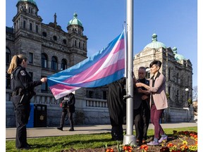 B.C.  Government staff raise the transgender flag at the legislature on Thursday, March 30.