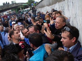 Buenos Aires' Province Security Minister Sergio Berni gestures to the media after being assaulted by bus drivers who were protesting the murder of a colleague, in Buenos Aires, Argentina April 3, 2023.