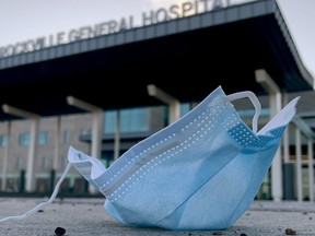 A facemask lies on the ground near the main entrance to Brockville General Hospital