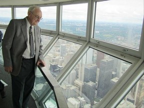 Ottawa's Stewart "Bud" Andrews stands in the CN Tower's SkyPod, nicknamed "Bud's Bubble," 447 metres above downtown Toronto. Andrews was a key figure in conceptualizing and building the CN Tower. Photos courtesy of the Andrews family.