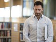 Ontario Education Minister Stephen Lecce waits for his introduction before speaking to the media at an Etobicoke library, in Toronto, Sunday, April 16, 2023.