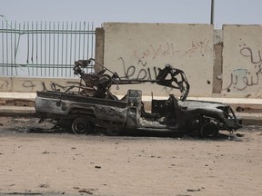 A destroyed military vehicle is seen in southern in Khartoum, Sudan, Thursday, April 20, 2023. The latest attempt at a cease-fire between the rival Sudanese forces faltered as gunfire rattled the capital of Khartoum. Through the night and into Thursday morning, gunfire could be heard almost constantly across Khartoum.