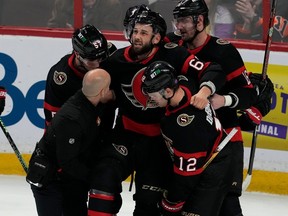 Ottawa Senators' Shane Pinto, Alex DeBrincat and Austin Watson help carry injured teammate Derick Brassard off the ice during second period NHL action, against the Philadelphia Fylers Thursday, March 30, 2023 in Ottawa.