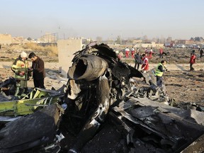 FILE - Debris are seen at the scene where a Ukrainian plane crashed in Shahedshahr southwest of the capital Tehran, Iran, Jan. 8, 2020. An Iranian court has sentenced an air defense commander allegedly responsible for the deadly downing of a passenger plane amid Iran-U.S. tensions several years ago, a state news agency reported Sunday, April 16, 2023.