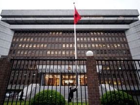 The Chinese national flag is raised in front of the Shanghai No.1 Intermediate People's Court in Shanghai on March 23, 2010.