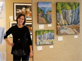 Julie Mercantini, a volunteer at the Foyer Gallery in Nepean, poses for a photo at the gallery Friday.