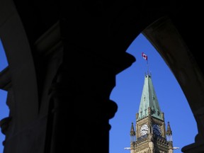 The Canada flag flies on top of the Peace Tower on Parliament Hill in Ottawa on Monday, March 6, 2023. Nine First Nations police service say Ottawa's "deliberate and wilful underfunding" of policing in their communities amounts to discrimination.
