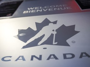 A Hockey Canada logo is seen on the door to the organizations head office in Calgary, Alta., Sunday, Nov. 6, 2022. The Canadian government has restored funding to Hockey Canada.