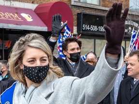 Minister of Foreign Affairs and Grand Marshal Melanie Joly and Prime Minister Justin Trudeau wave to the crowd at the Hellenic Community of Greater Montreal's annual Greek Independence Day Parade on Sunday March 27, 2022