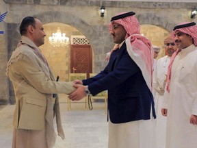In this handout photo released on April 9, 2023 by the Houthi group's media arm Ansar Allah, head of the Houthi's supreme political council Mahdi al-Mashat, left, shakes hands with Saudi Arabia's Ambassador to Yemen Mohammed bin Saeed Al-Jaber, in Sanaa, Yemen. Saudi officials were in Yemen's capital Sunday for talks with the Iran-backed Houthi rebels, as part of international efforts to find a settlement to Yemen's nine-year conflict. (Ansar Allah Media Office)