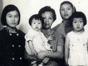 Young Talia Chan is held in the arms of her mother, Lin Lu, and her sisters (left to right) Anna, Fong, and Lucy.