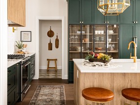 West of Main photograph Caption: The award-winning kitchen in the Oliver pops with deep green cabinets (Essex Green from Benjamin Moore).