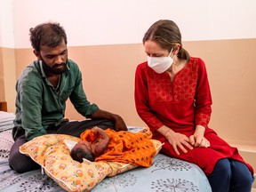 Dr. Megan Doherty checks on the 15-day-old Mallesh at the Mandara Hospice for Children in Hyderabad, India, March 16, 2022.