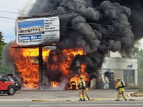Firefighters battle a garage fire at SAAB gas centre at the corner of Ogilvie and Cyrville roads in Ottawa on May 15.