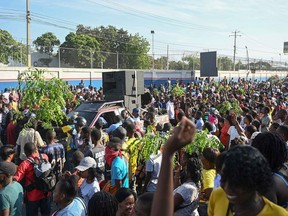 Factory workers and employees in the clothing manufacturing sector take part in a demonstration to demand higher wages in Port-au-Prince, Haiti, May 9, 2023.