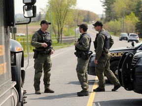 Bourget, May 11: Police block off the area outside a home on Laval Street, the scene of the shooting in which Sgt. Eric Mueller died. Two OPP officers were also wounded.