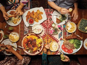A dinner party featuring recipes from Yogurt & Whey, clockwise from top left: yogurt-marinated fried chicken with saffron honey, cucumber sekanjabin sharbat, yogurt, spinach boorani, fried tongue sandwiches with labneh, chips and yogurt, tachin and upside-down cake.