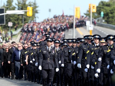 Thousands of officers march ahead of the hearse carrying Sgt. Eric Mueller to his funeral at the Canadian Tire Centre in Ottawa Thursday morning. The police officer was killed when responding to a call in Bourget in the early-morning hours of May 11th, along with two other officers who were wounded at the same time.
