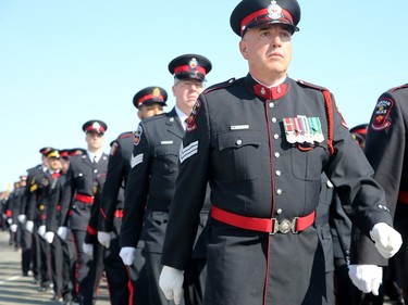 Thousands of officers march ahead of the hearse carrying Sgt. Eric Mueller to his funeral at the Canadian Tire Centre in Ottawa Thursday morning.