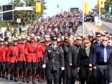 Thousands of officers march ahead of the hearse carrying Sgt. Eric Mueller to his funeral at the Canadian Tire Centre in Ottawa Thursday morning. The police officer was killed when responding to a call in Bourget in the early-morning hours of May 11th, along with two other officers who were wounded at the same time.