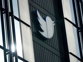 FILE - A Twitter logo hangs outside the company's offices in San Francisco, Dec. 19, 2022. Elon Musk said Thursday, May 11, 2023, that he has found a new CEO for Twitter, or X Corp. as it is now called. He did not name the person but she will be starting in about six weeks.